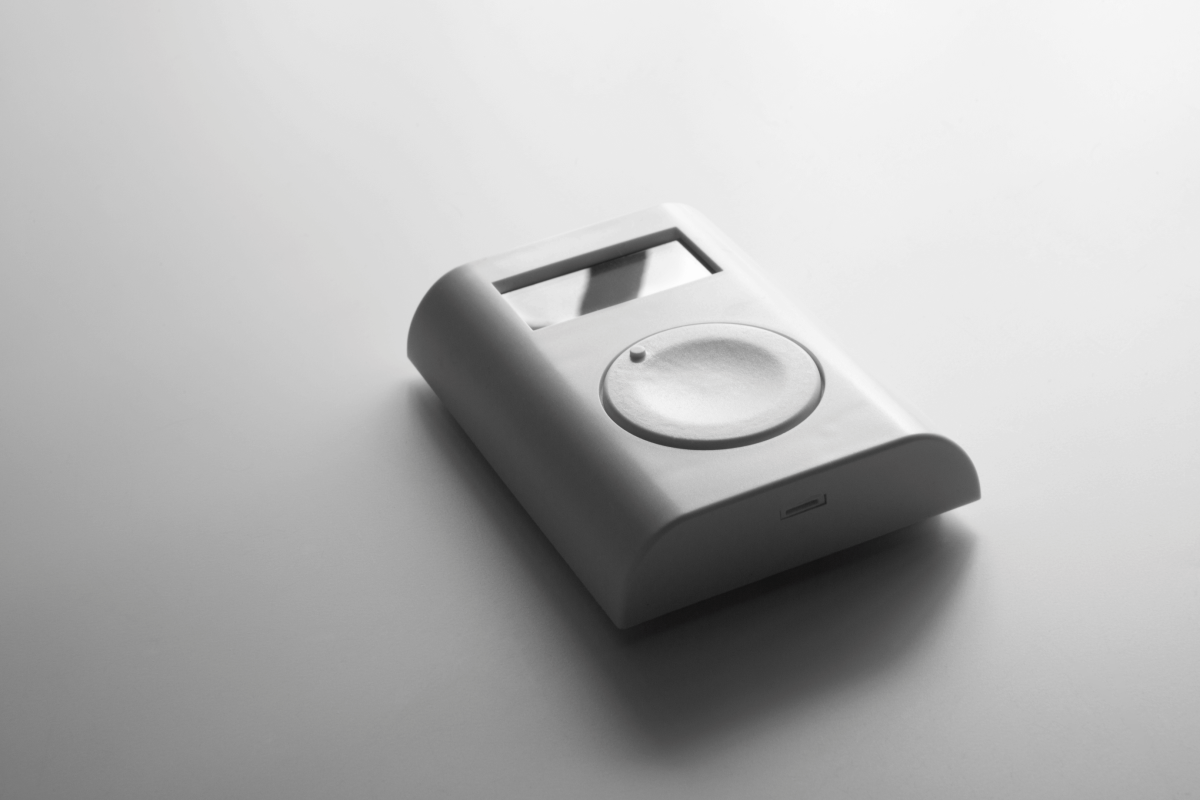 Nahaufnahme eines Jablotron-Handsenders in minimalistischem Design. Das Gerät liegt auf einer hellen Oberfläche und zeigt ein zentrales Bedienrad.
